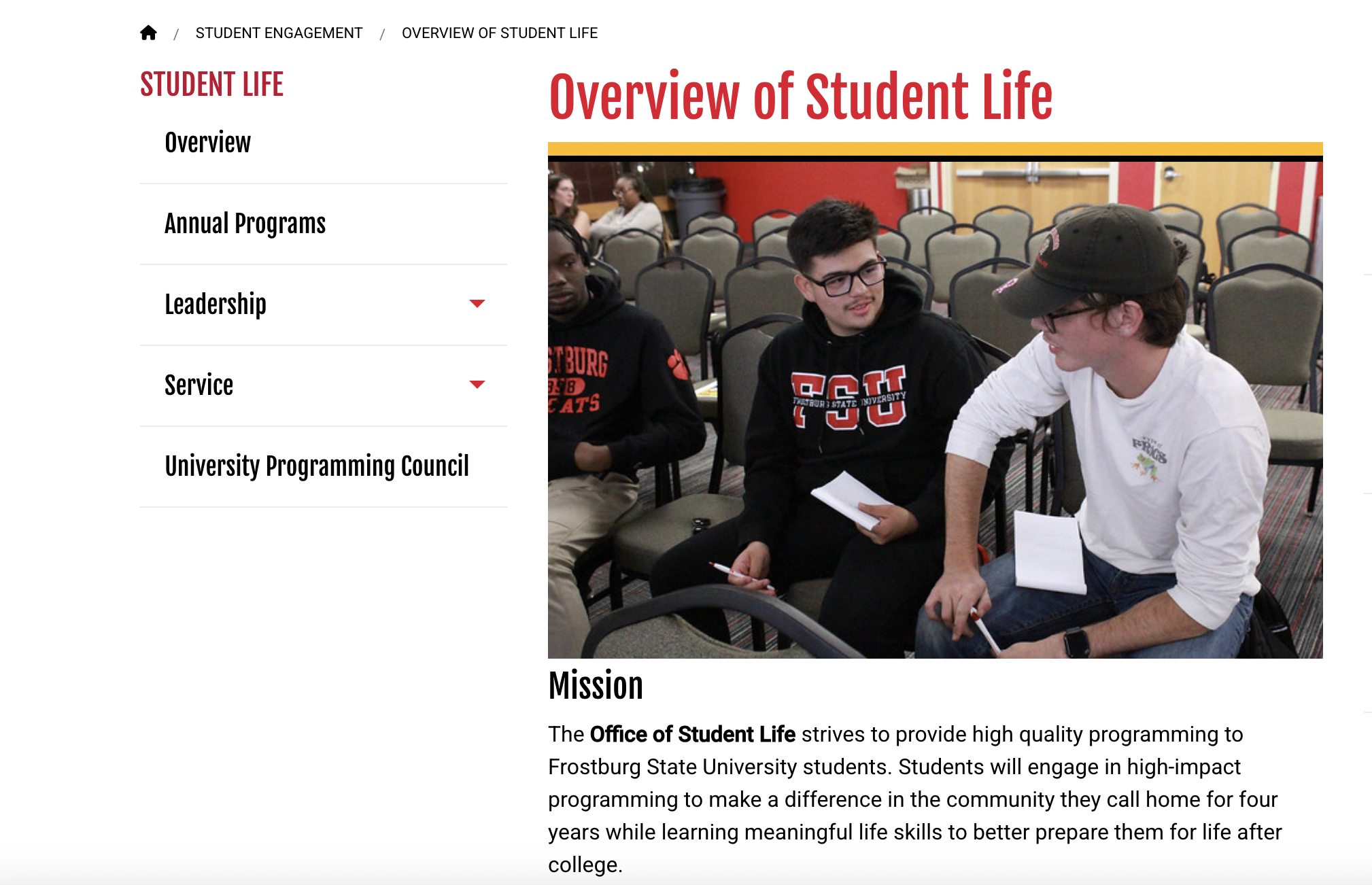 Students engaged in discussion during a group activity in a classroom setting, highlighting collaboration in student life programming.