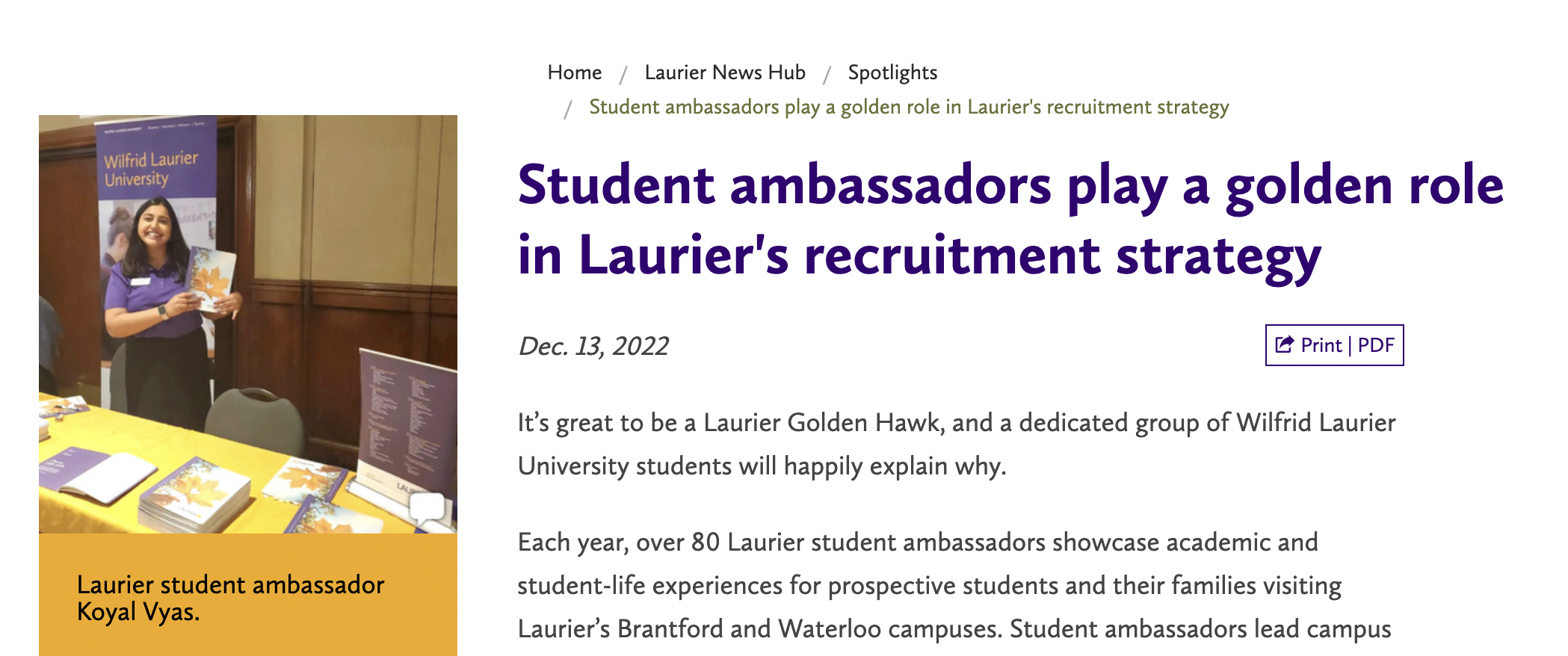 A student ambassador from Wilfrid Laurier University engages with prospective students at a recruitment event.